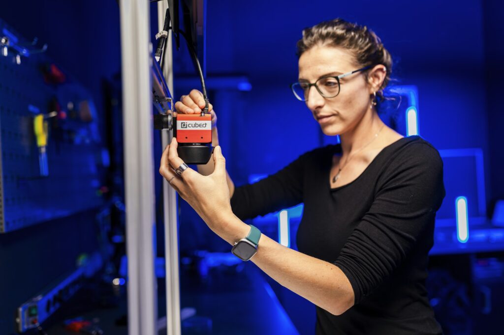 Woman installing cubert hyperspectral camera in lab